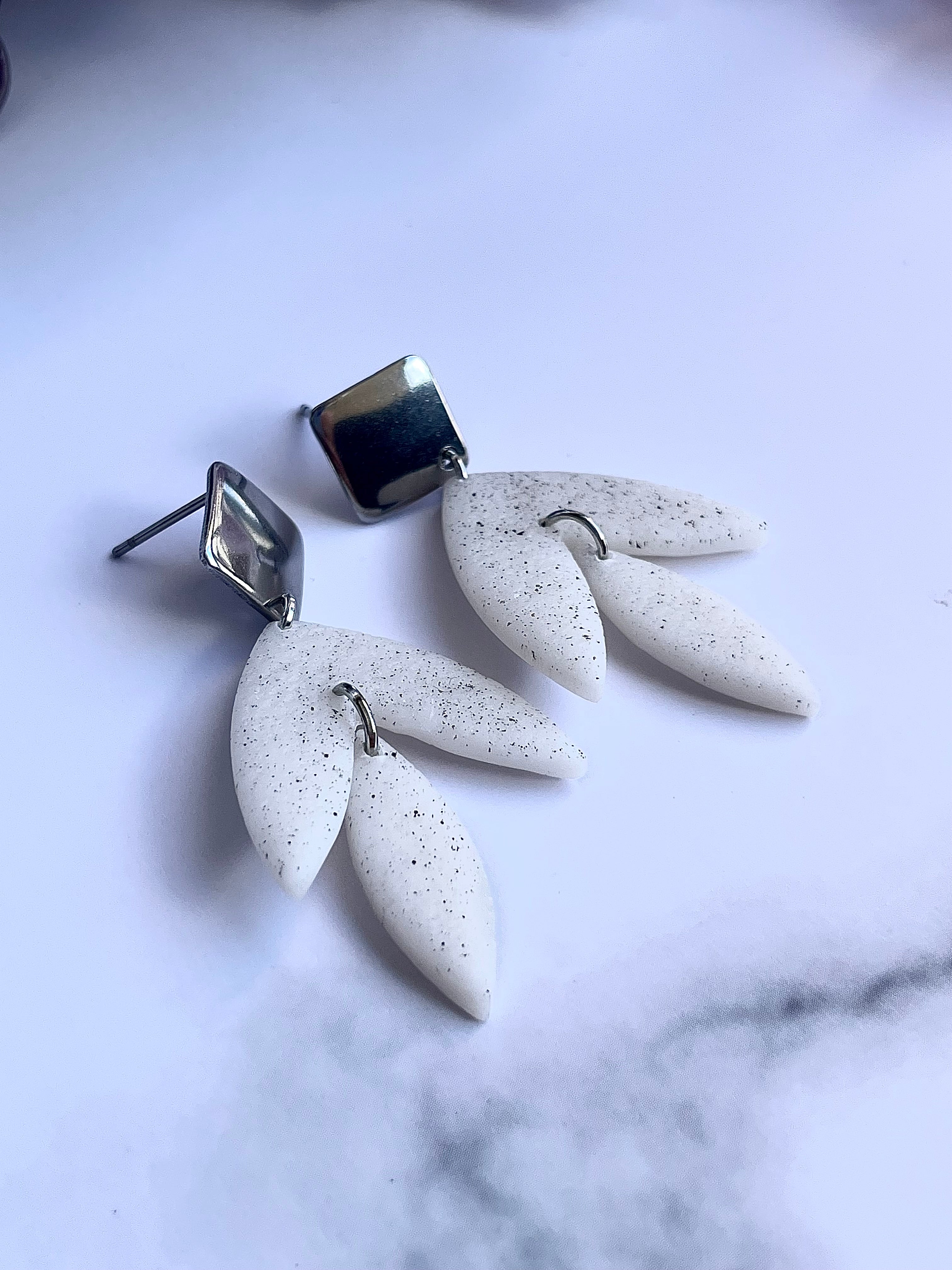 Matt textured leaf earrings with black speckles
