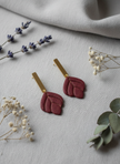 Burgundy earrings with botanical styling