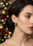 Different model wearing earrings with Christmas styling