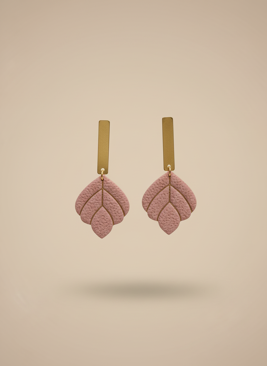 Dusty rose earrings on beige background