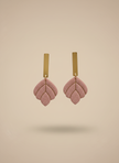 Dusty rose earrings on beige background