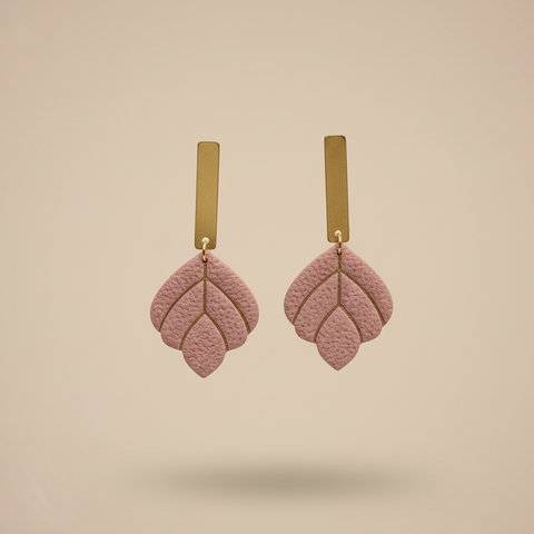 Dusty rose earrings on beige background