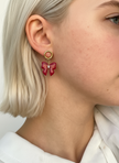 Fashion model wearing red bow earrings