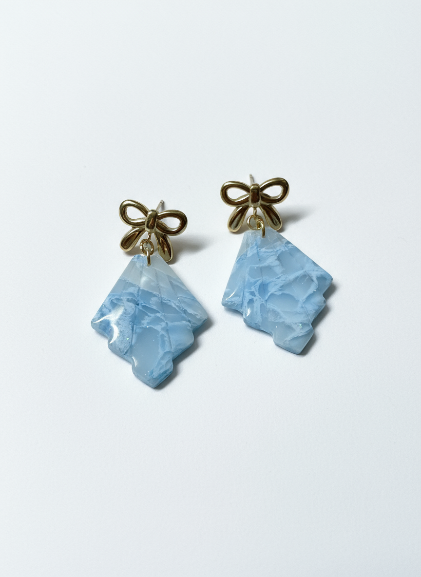 Frosted earrings on neutral commercial background