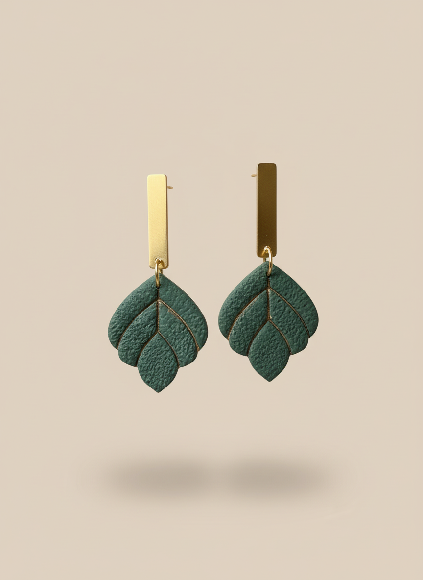 Green earrings on beige background