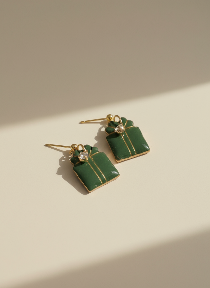 Green gift box earrings with professional studio background