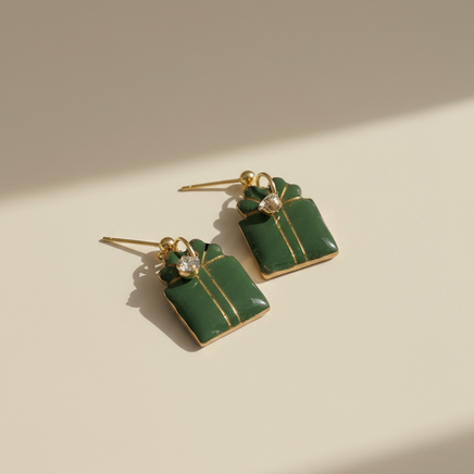Green gift box earrings with professional studio background