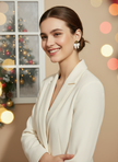 Model in white blazer wearing bow earrings - Christmas vibes