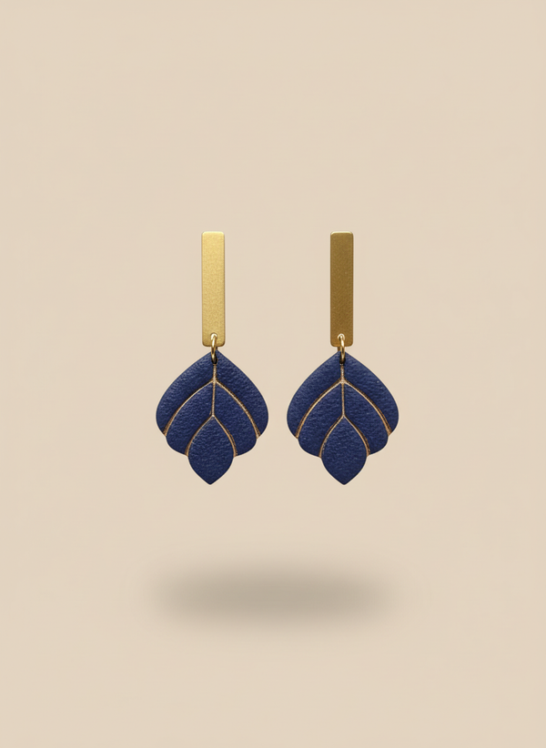 Navy earrings on beige background