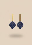 Navy earrings on beige background