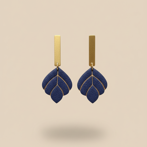 Navy earrings on beige background