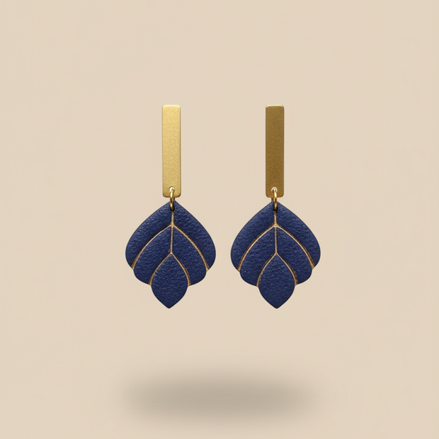 Navy earrings on beige background