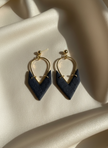 Navy earrings on cream silk