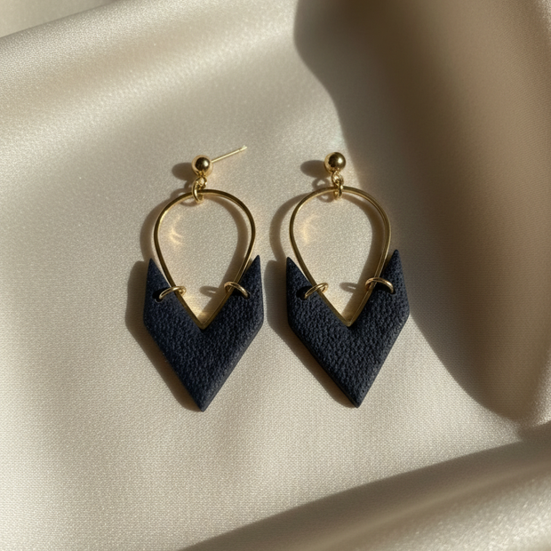 Navy earrings on cream silk