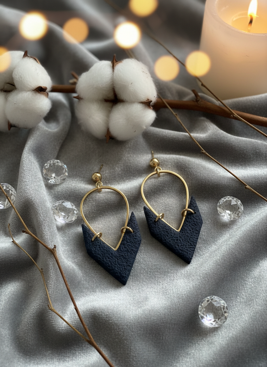Navy earrings on velvet with candlelight