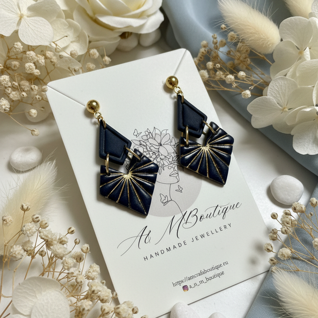 Navy geometric earrings with natural floral background