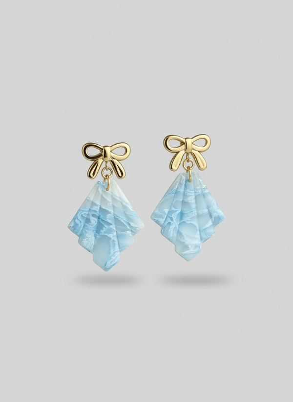 Professional product photo of frosted earrings on neutral background