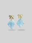 Professional product photo of frosted earrings on neutral background