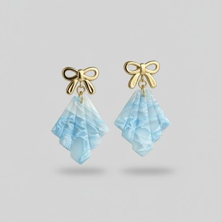 Professional product photo of frosted earrings on neutral background