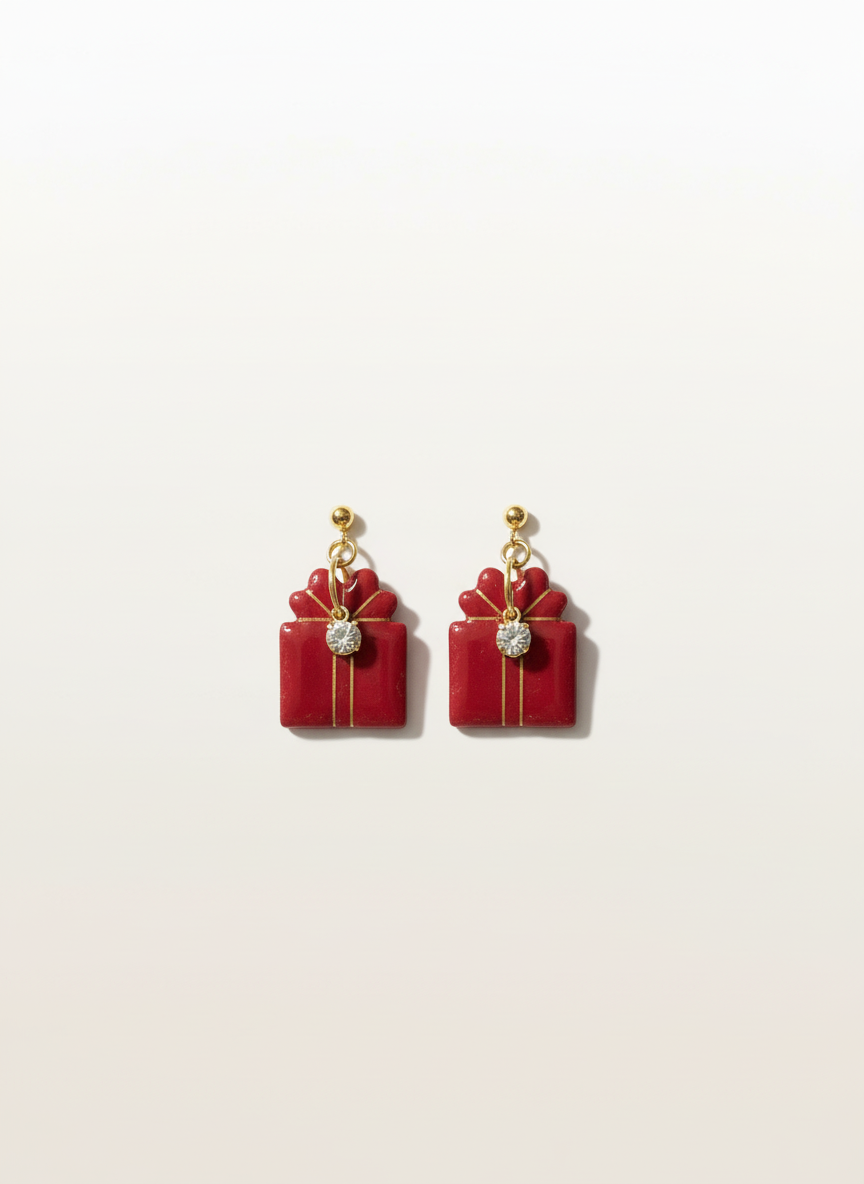 Red gift box earrings on seamless neutral background