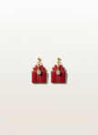 Red gift box earrings on seamless neutral background