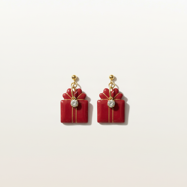 Red gift box earrings on seamless neutral background